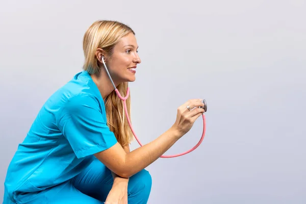 Nurse Blue Scrubs Using Stethoscope Invisible Patient — Stock Photo, Image