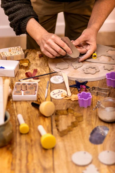 Ceramics workshop. Master craftsman works with sandpaper.