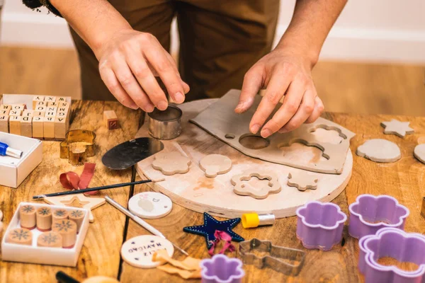 Ceramics workshop. Men\'s hands working with accessories.