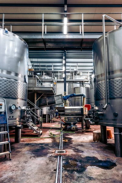 Wine fermentation tanks. Wine factory. Steel barrels in winery.