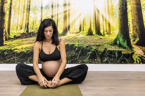 Pregnant woman doing prenatal yoga