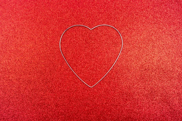 Valentines day background. Gold heart profile on red glitter background.