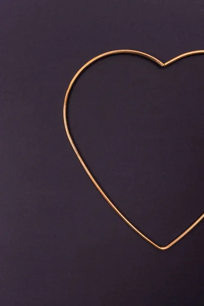 Valentines day background. Gold heart outline on black background.