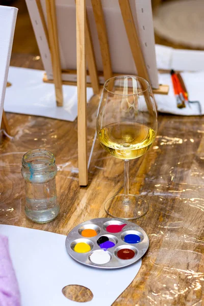 Art & Wine. Glass of white wine and acrylic paint.