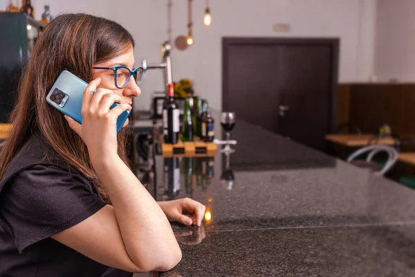 stock image Waiter talking on mobile phone at cafe