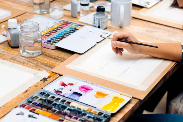 stock image Watercolor Painting Workshop. Close-up of a young girl's hand holding a paintbrush.