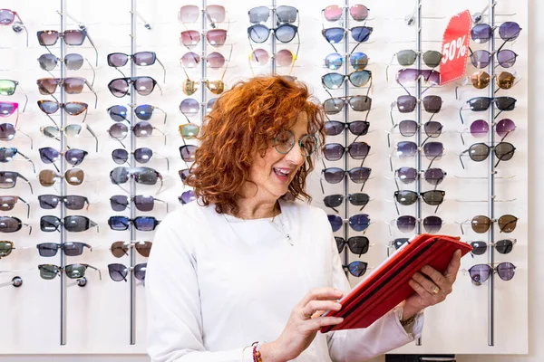 Beautiful Redhead Woman Optician Trying Eyeglasses — Stock Photo, Image