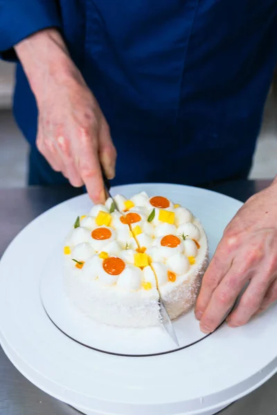 Pastry Chef. Cutting the cake with a chef\'s knife.