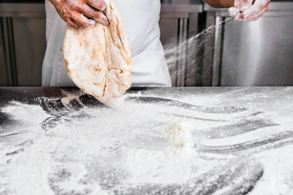 stock image Master Baker. Stretching the dough to make quality bread.