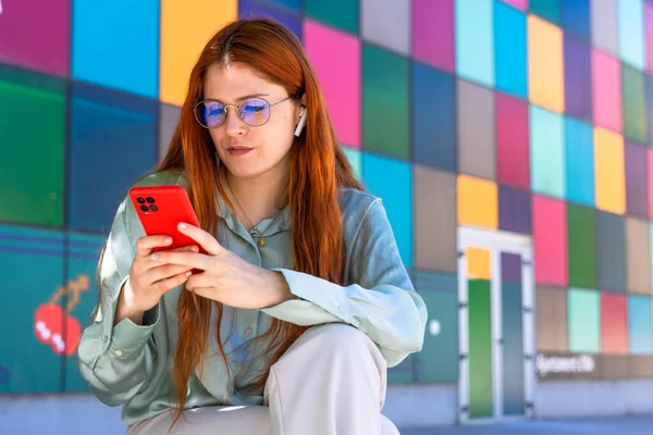 Redhead Girl. Tech-Savvy Beauty: Gorgeous Redhead Engaged in Mobile Telecommuting and Digital Art
