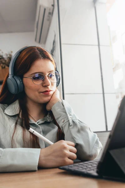 stock image Redhead Girl. Red haired Beauty Engages in Remote Work at Trendy Caf