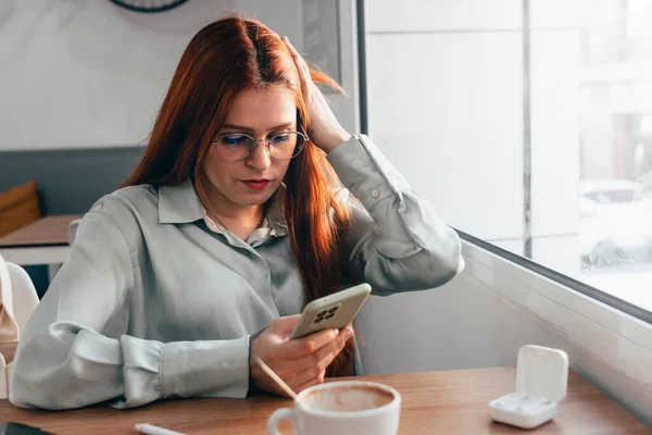 Stock image Redhead Girl. Tech-savvy Red-haired Woman Thrives in Remote Work Environment