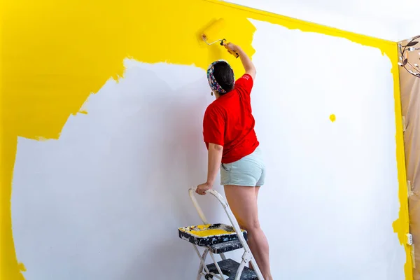 Stock image DIY Home Renovation: Middle-aged Woman Painting Yellow Walls