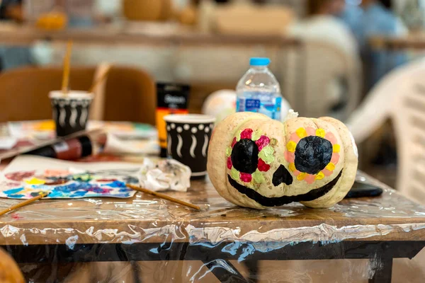 Children's painting class. Painting day with parents in class painting pumpkins.