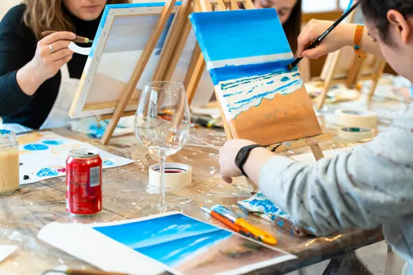 Art and Wine workshop. Middle aged woman learning to paint.