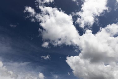 Mavi gökyüzünde beyaz kabarık bulutlar. Küçük bulutlarla mavi gökyüzü arkaplanı.