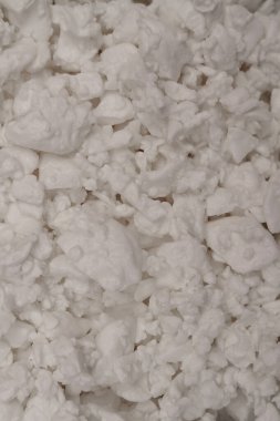 Velvety-textured dairy curd close-up. Cottage cheese texture background. Top view. Selective focus