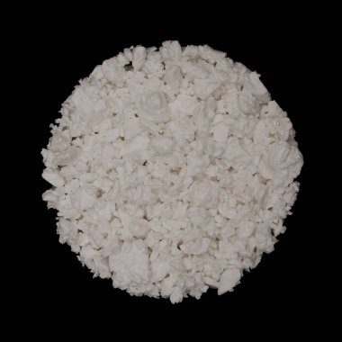 Cottage cheese round texture background isolated on black background. Tangy cultured product. Top view