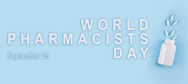 World pharmacists day Banner. Annual event observed on September 25. International profession Holiday concept with white lettering typography and drugs isolated on blue background