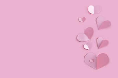 Pembe arka planda bir sürü kağıt konfeti kalbi var. Sevgililer Günü afişi şablonu