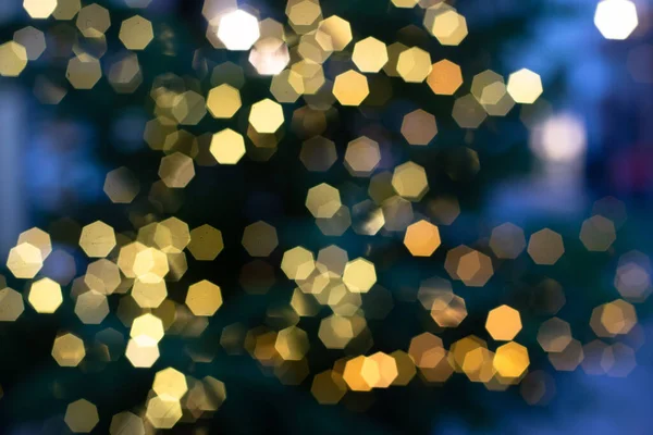 Bokeh background for christmas and new year, defocused round lights in golden and blue color, flare overlay