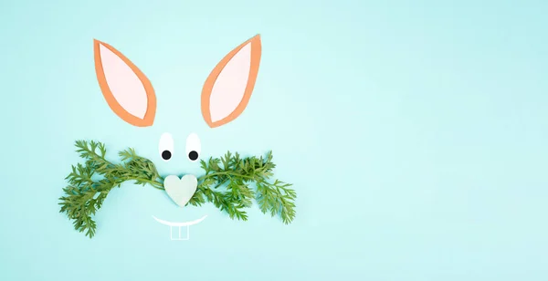 Easter bunny face, heart shaped nose , whiskers from carrot leaves, holiday greeting card, spring season