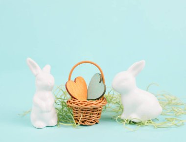 Wicker basket with hearts and an easter bunny, rabbit brings gift of love, greeting card for holiday 