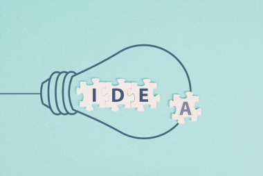 Idea in progress, light bulb, starting a new business, development and growth concept, brainstorming for solutions, jigsaw pieces 