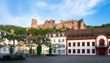 Heidelberg, mediaevial castle, red sandstone ruins tower looms majestically over the Neckar river and valley clipart
