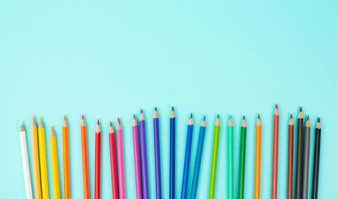 Renkli kalem koleksiyonu, okula dönüş, malzeme çizimi, kopya alanı olan mavi arkaplan