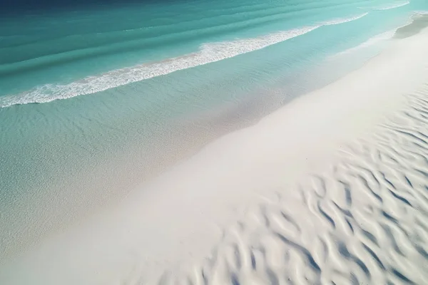Experience the beauty of nature with this stunning aerial view of a pristine white sand beach and crystal clear waters.