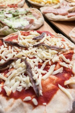 Pişirmek için çeşitli çiğ pizzalar. Restoranda. Pizzacı. İtalyan yemeği..