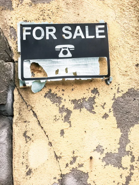 Old advertisement of a house for sale. Real estate crisis concept.