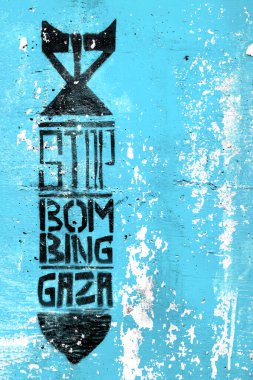 Graffiti on the vintage blue wall depicting the silhouette of a bomb. Inside message: STOP BOMBING GAZA. Copy space. Fully editable. clipart