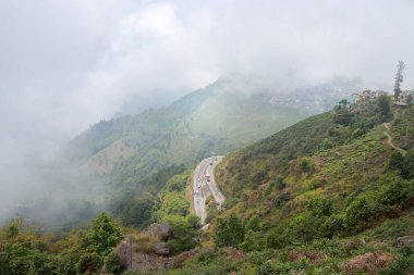 beautiful road in the hill town of Kurseong city of Darjeeling in West Bengal of India.  clipart