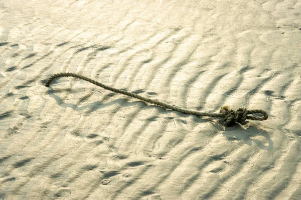 地元の漁師は網を干潮で縛って魚を捕まえようとロープを固定しました — ストック写真