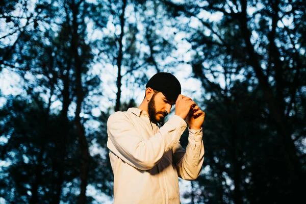 Stock image Portrait of a young bearded man wearing a black cap at countryside