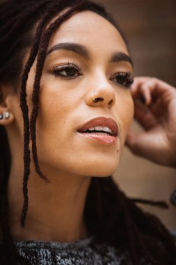 Rastalı güzel bir kadının portresi, altında parlak bir gülümseme..