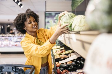 Müşteri süpermarket üretim bölümünde savoy lahanası seçiyor