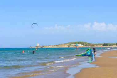 Vieste, Italy. View of the Scialmarino Beach with people practicing water sports, on a Summer day, along the coast of Vieste. September 7, 2022 clipart