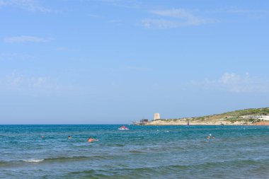 Vieste, İtalya. Scialmarino sahilinden Tufara Körfezi 'nin trabucco' su ve Porticello Kulesi. Vieste sahilinde bir yaz günü. 7 Eylül 2022