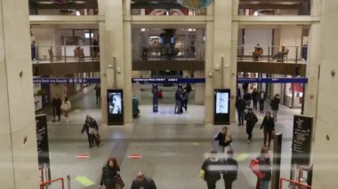 Turin, Italy. View from the upper floor of the entrance to Porta Nuova Station, with many people walking towards the platforms or towards the exit. Slow motion video. 2022-11-18.