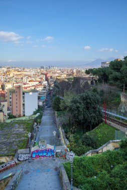 Naples, Italy. View on a sunny January day of the historic center of Naples seen from Corso Vittorio Emanuele. In the foreground the stairs of Montesanto. Vertical image. January 3, 2023.
