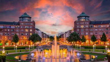 Mannheim, Germany. View on Friedrichsplatz at sunset with fountain creating splendid water and color effects. 2013-06-16. clipart
