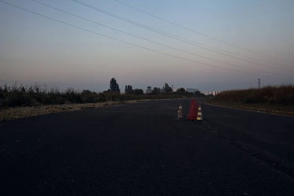 Empty road in an abandoned industrial complex at dusk