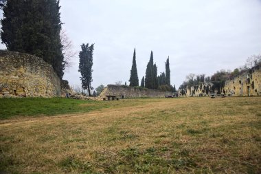 Sonbaharda bulutlu bir günde parktaki taş duvarlar arasında geniş bir patika.