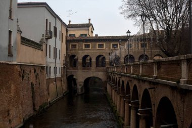 River In a town with an ancient porchway below street level on a cloudy day