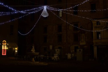 Cobbled square with decorations at night