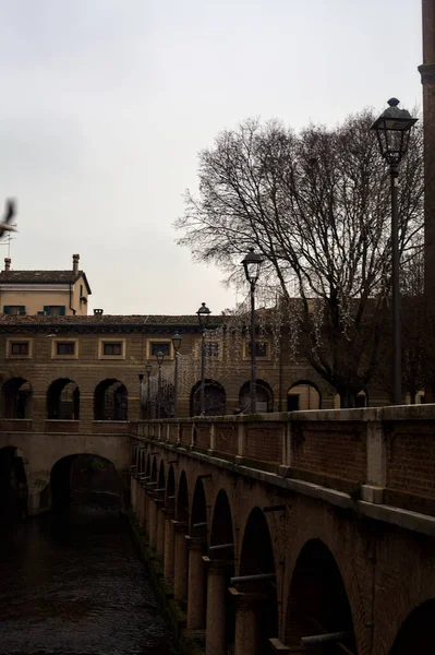 River In a town with an ancient porchway below street level on a cloudy day