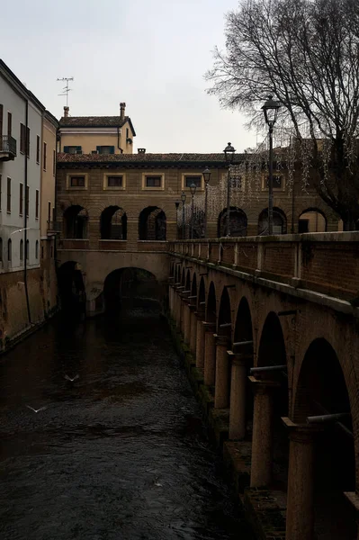 River In a town with an ancient porchway below street level on a cloudy day